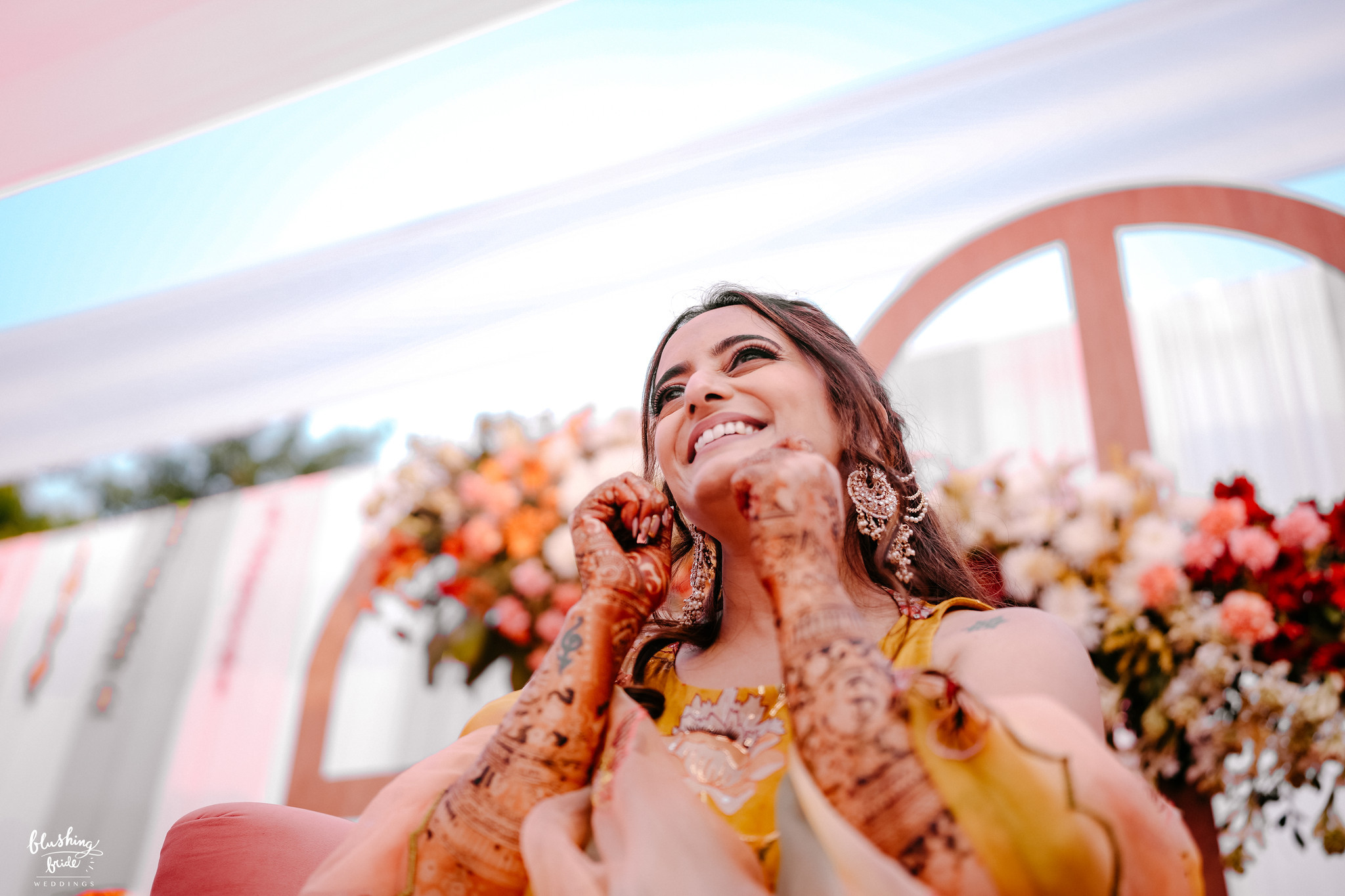 Bride laughing during her mehendi