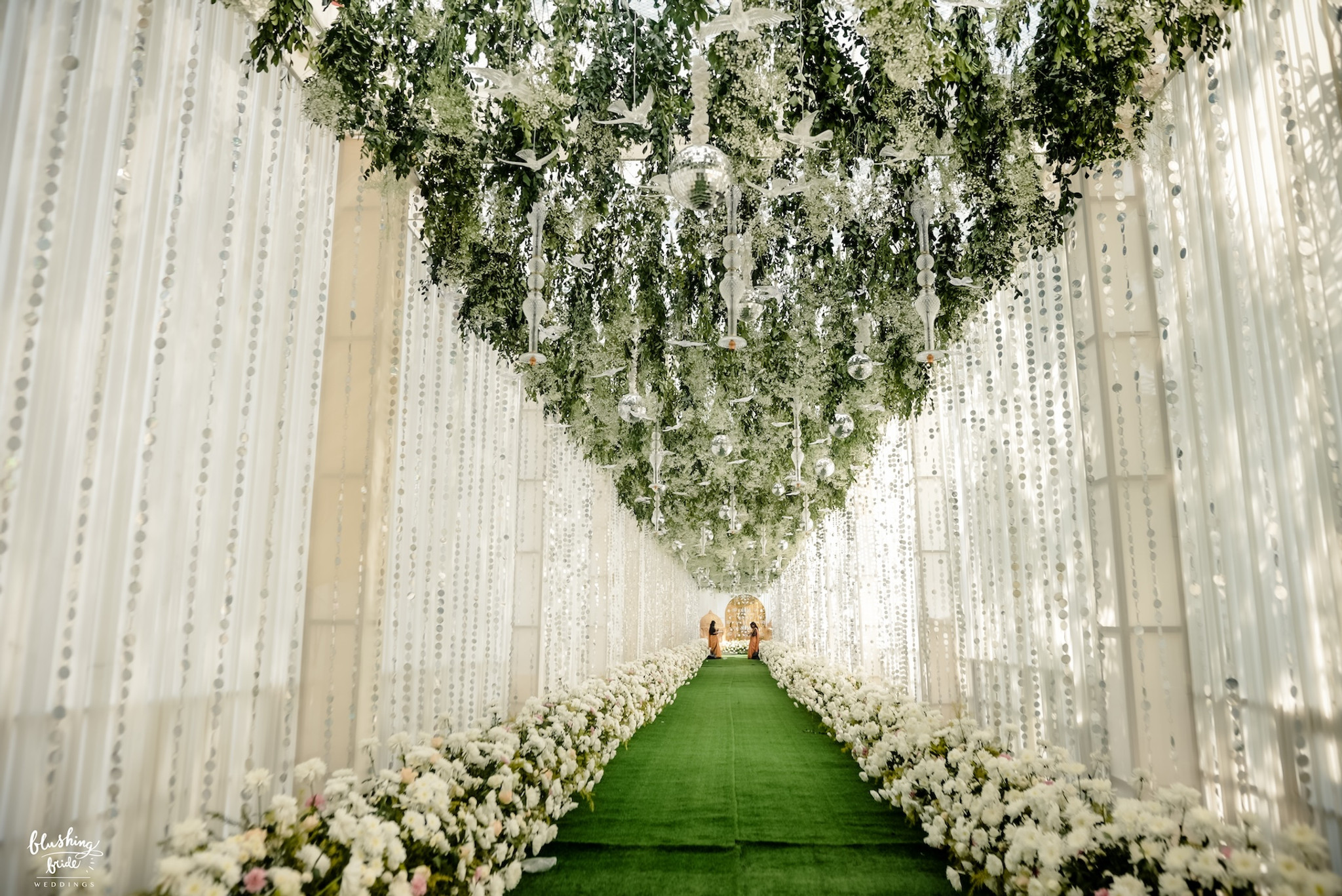 White drape corridor leading to the mandap