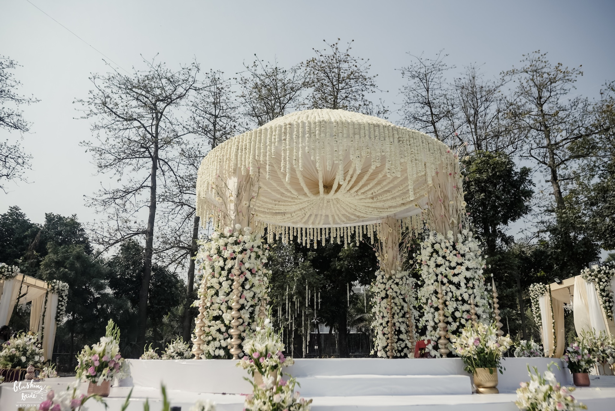 Wide view of a mandap and guest seating on a lawn