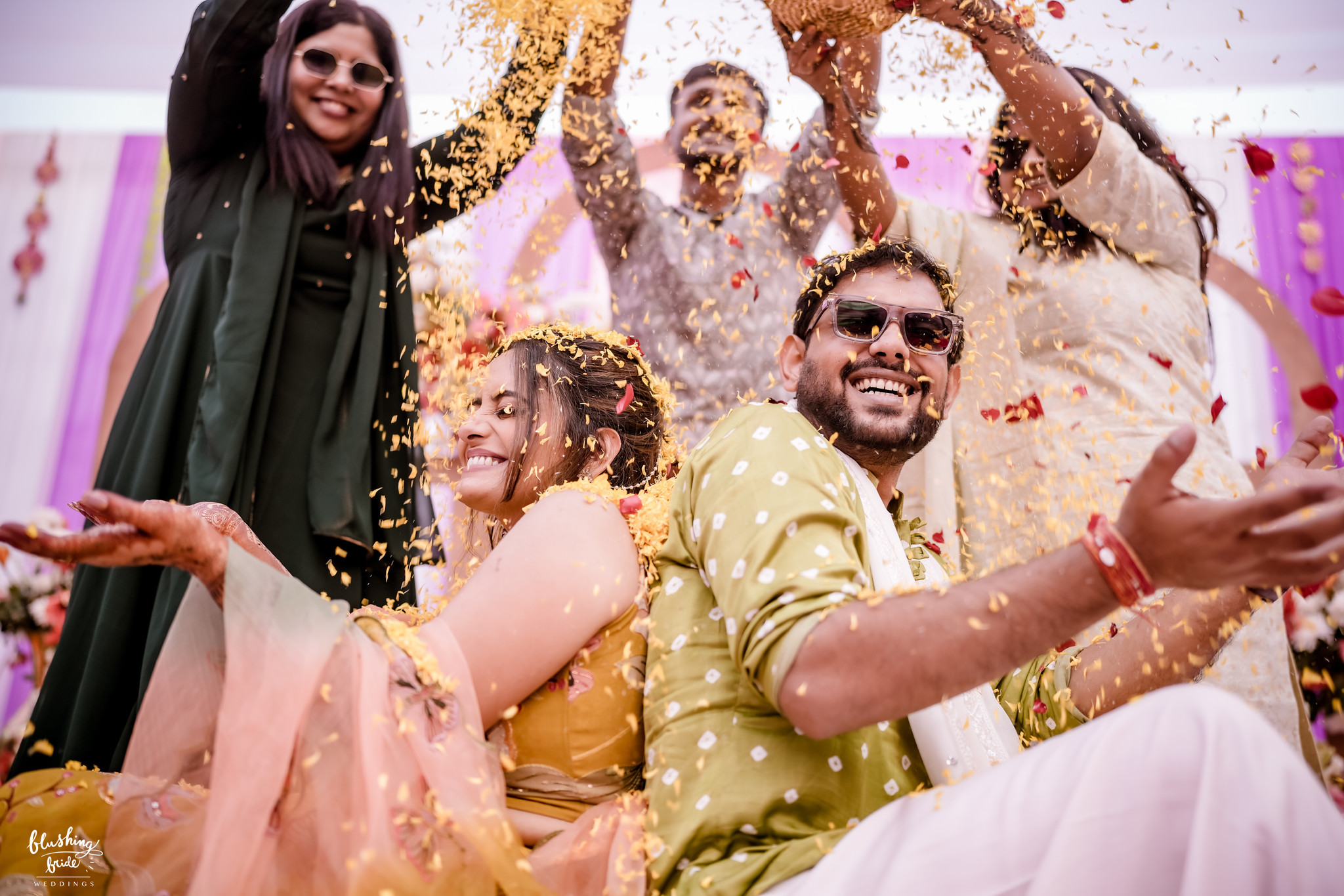 Guests showering the couple with flower petals
